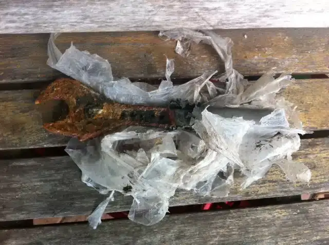 Plastic bags and a rusted fitting pulled out of a blocked drain
