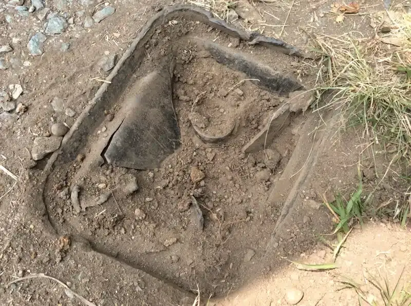 Broken water meter box lid in the ground