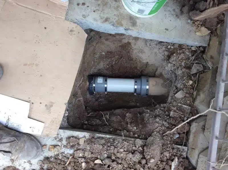 New PVC pipe section joined upstream of a manhole